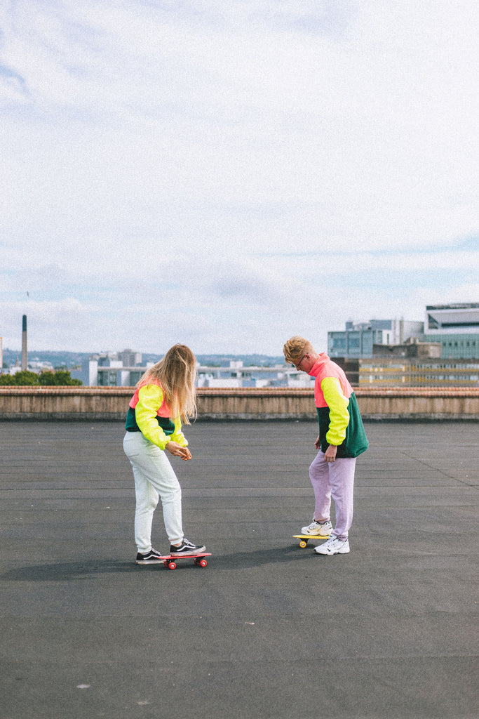 ROOFTOP PHOTOSHOOT ELN MODELS IN NEON SQUEEZE FLEECE LINKING TO WEAR CARE SHARE MOTTO BY ELN